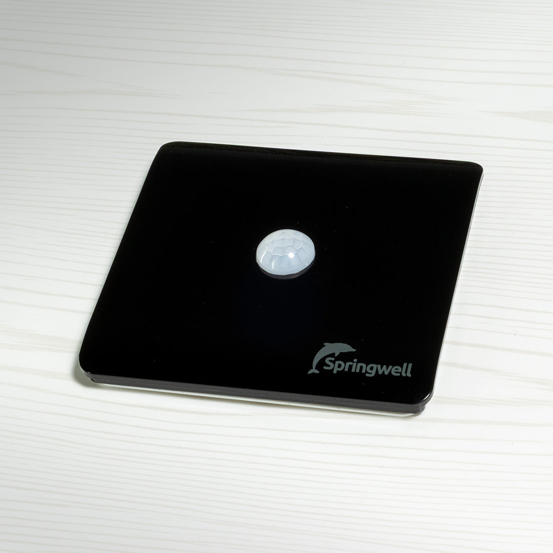 Black motion sensor with 'Springwell' logo on a white background
